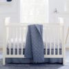 CozyCradle Convertible Crib in a white finish, featuring clean lines and a timeless design. The crib is set in a cozy nursery with soft bedding, offering a safe and stylish sleeping space for babies. This crib can be converted into a toddler bed as your child grows, combining functionality and elegance.