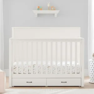 PureComfort 4-in-1 Convertible Storage Crib in a neutral wood finish, featuring built-in storage drawers and a sleek, modern design. The crib is staged in a cozy nursery setting with soft bedding and plush toys, showcasing its versatility and space-saving functionality.