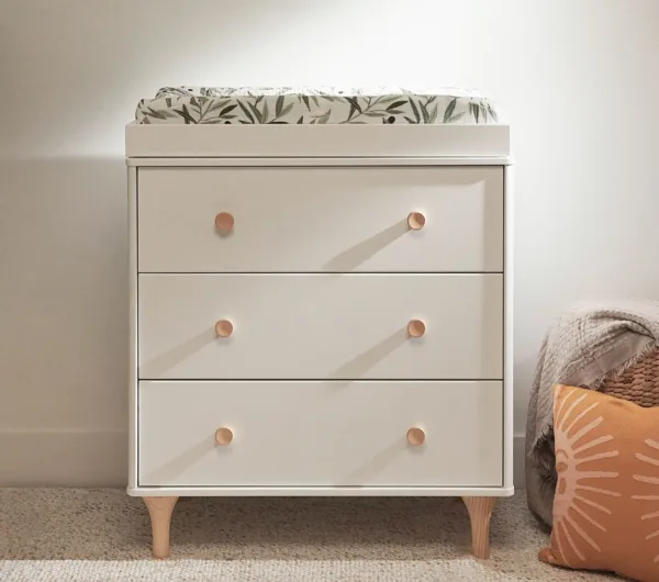 DreamNest Lolly 3 Drawer Dresser & Topper Set in a modern nursery setting, showcasing its sleek design and ample storage space.