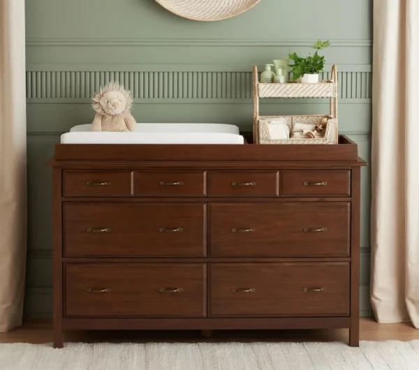 PureComfort Extra Wide Dresser & Topper Set in a nursery, showcasing six spacious drawers and a removable changing topper for added versatility and style.