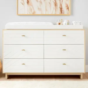 BabyBliss Extra Wide Dresser & Topper Set in a nursery, featuring a spacious design with multiple drawers and a removable changing topper.