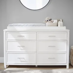 Dreamland Extra Wide Dresser & Topper Set in a nursery, showcasing its spacious design with multiple drawers and a removable changing topper.